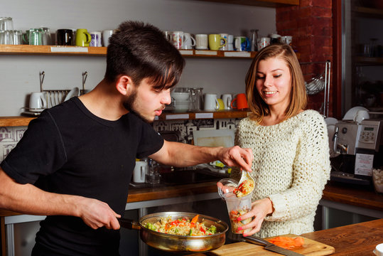 young couple cooking on kitchen