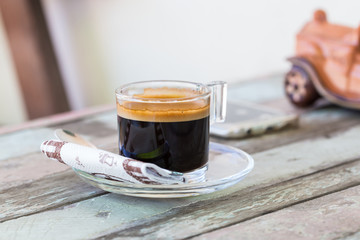 Hot cup of Coffee on an old wooden table