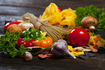 pasta, noodles, spaghetti, Parmesan, basil, pesto, tomatoes. Italian Cuisine. Concept of healthy food.