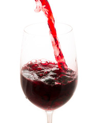 pouring red wine from bottle in the glass