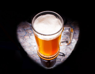 A glass of beer on a black background