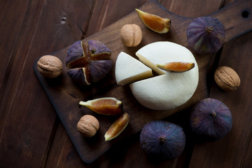 Adygea cheese with fresh fig fruits and walnuts, view from above