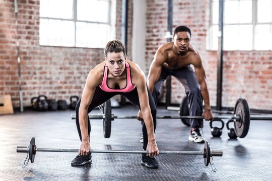  Fit couple lifting weight together