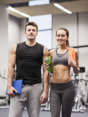 Fototapeta na wymiar happy couple in gym with water and tablet pc