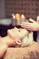 Obraz na płótnie Canvas close up of woman having face massage in spa