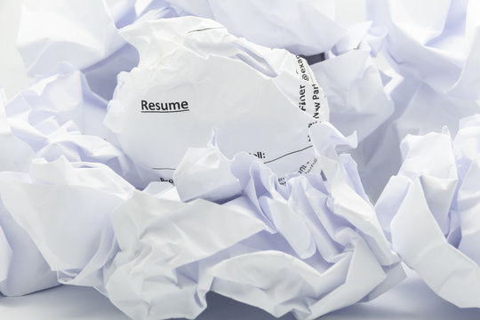Concept of resume crumpled up and thrown away in the trash.