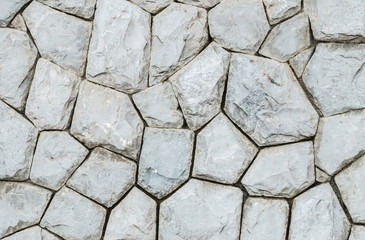 Closeup old stone wall in the garden texture background