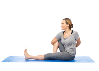 woman making yoga in twist pose on mat