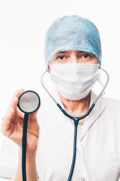 Doctor with face mask holding stethoscope