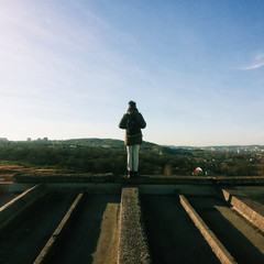 Man stands on the edge of the building