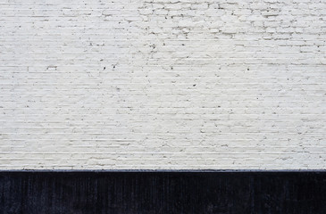 White brick wall and black skirting
