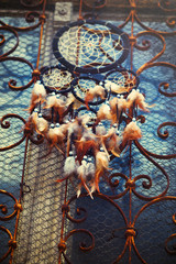 Dream Catcher and ornamental  window on background.