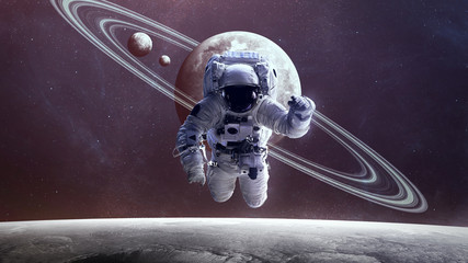 Astronaut in outer space against the backdrop of the planet. Elements of this image furnished by NASA © Vadimsadovski