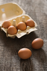 Box with six eggs on the old rustic background