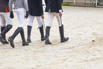 Riders walking a course at horse jumping competition