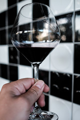 Glass of red wine in hand