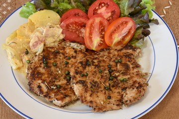 Pepper steak served with roasted potato and salad.