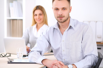 Successful businesspeople  working at meeting in office. Businessman looking at camera. Start up business concept.