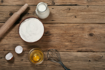 Flour in a bowl with ingredients for preparing baked products