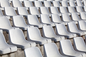 empty plastic seats on football stadium