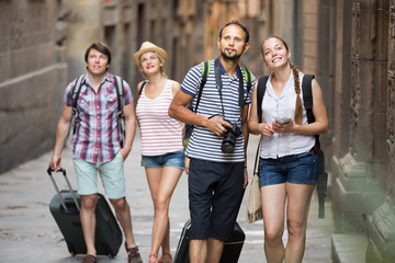 Group of happy tourists watching landmark
