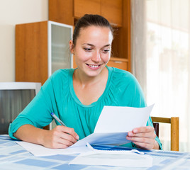 girl working with documents at home