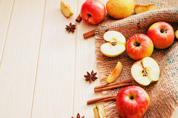 
background, fresh apples with cinnamon and spices on a light wooden background
