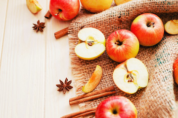 
background, fresh apples with cinnamon and spices on a light wooden background