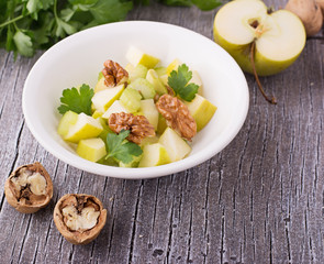 Light fresh spring salad with green apple, stem celery, walnuts