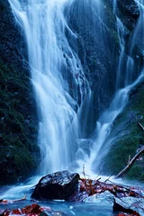 Poster de jardin Cascades Water spray below small waterfall on mountain stream. Broken branches in water