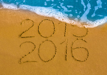 Happy New Year 2016 replace 2015 concept on the sea beach