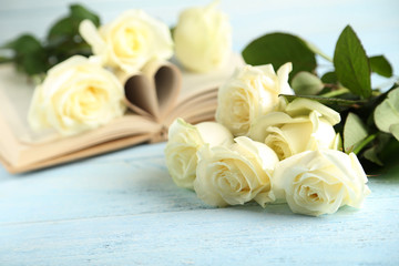 Bouquet of white roses on blue wooden background