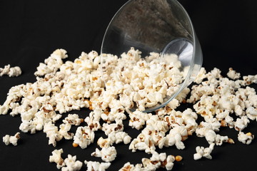 Popcorn in a glass bowl on black background
