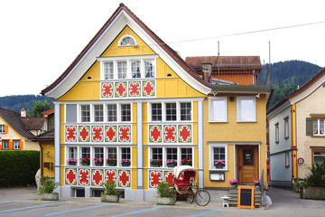APPENZELL, SWITZERLAND- JUNE 29, 2015: Ancient unique colourful house in historic medieval old town. Appenzell is well-known for its colourful houses with painted facades. - 98194996
