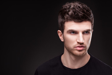 Obraz premium Stylish guy close up portrait on black background