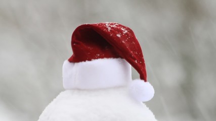 snowflakes falling on santa hat, xmas
