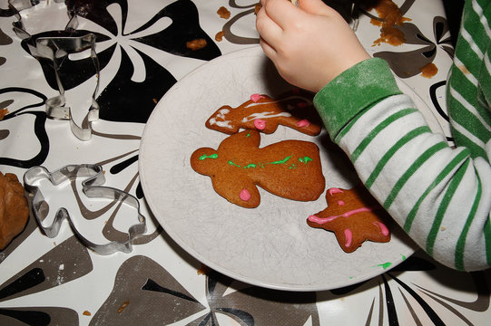 Child decorating gingerbread