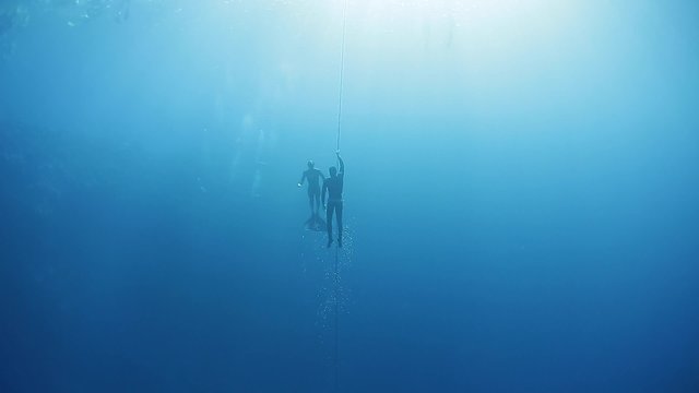 Free divers working out in the open sea