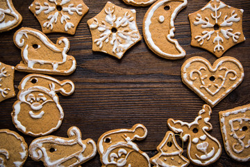Gingerbread cookies over wooden background..