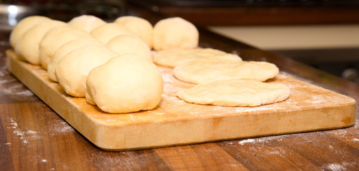 Dough lumps on a chopping board for future pies