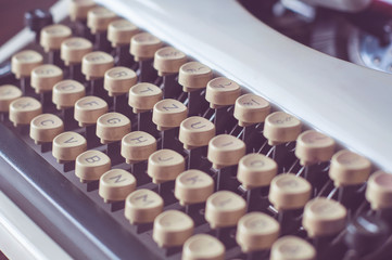 an old typewriter on old wooden table with coffee and old camera