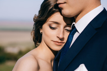 Bride and groom at wedding Day walking Outdoors on castle territory. Bridal couple, Newlywed woman and man embracing with love