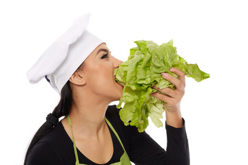 Woman cook biting lettuce