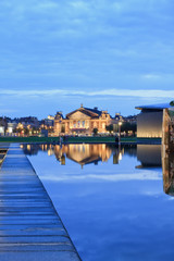 Concert hall at twilight reflected in a pond, Amsterdam, Netherlands