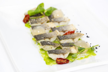 baked black cod fish on a white background in the restaurant