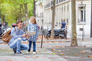 Happy family with map of european city outdoors