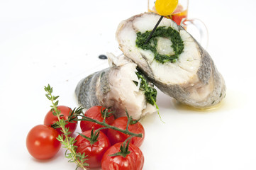 Fototapeta na wymiar Baked fish on a white plate in a restaurant