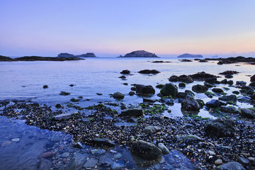 Bay with cobblestones and pebbles at twilight, Dalian, China