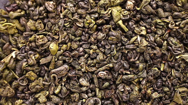 Green tea leaves close up rotation