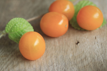 yellow tomatoes with mint leaves